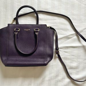 Coach purse. Dark purple. Cross body strap and zipper closure.